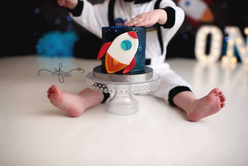 Out of this world smash cake photography session Astronaut Space first birthday