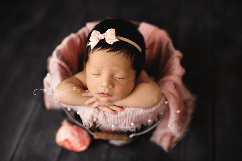 Newborn baby posed in bucket Newborn Photographer in CT