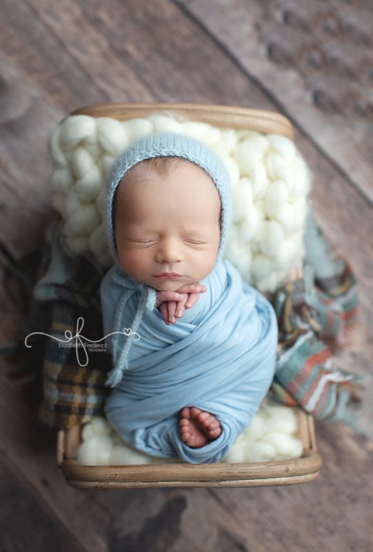 newborn baby in a little bed, baby boy newborn photos, newborn photography, wrapped newborn baby | Elizabeth Frederick Photography