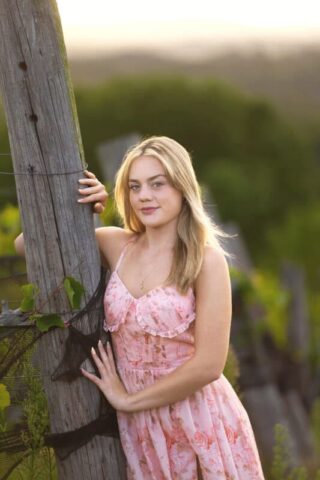 Connecticut senior photographer capturing a high school senior in a pink dress during a vineyard photo session at Gouveia Vineyards.