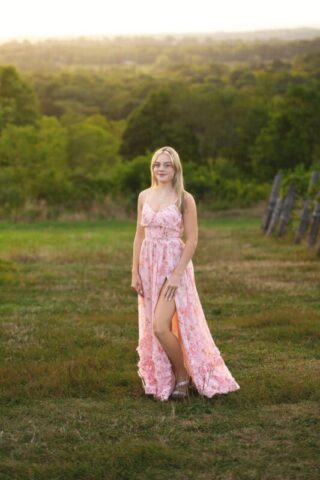 Wallingford CT senior photography session at Gouveia Vineyards, elegant senior portrait in a pink dress with rolling vineyard hills.