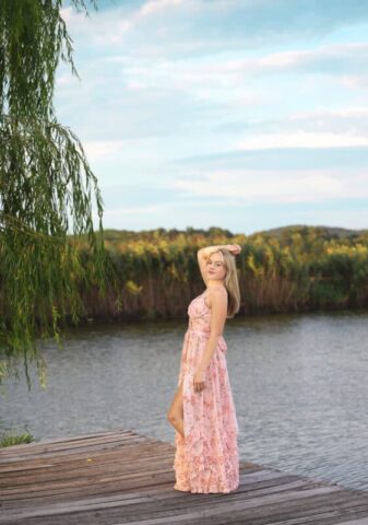Connecticut senior photographer capturing a high school senior in a pink dress during a vineyard photo session at Gouveia Vineyards.