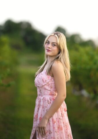 Connecticut senior photographer capturing a high school senior in a pink dress during a vineyard photo session at Gouveia Vineyards.