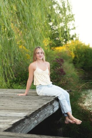 Connecticut high school senior portrait by the pond at Gouveia Vineyards, senior girl in a casual outfit during outdoor photo session.