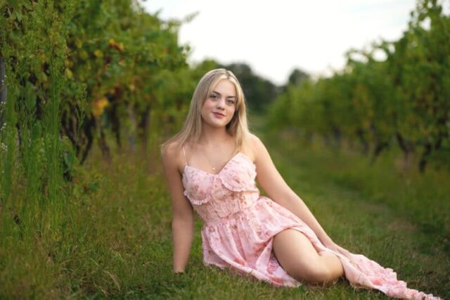 Connecticut senior photographer capturing a high school senior in a pink dress during a vineyard photo session at Gouveia Vineyards.