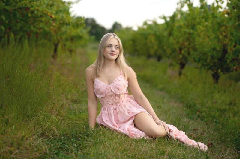 Wallingford CT senior photography session at Gouveia Vineyards, elegant senior portrait in a pink dress with rolling vineyard hills.