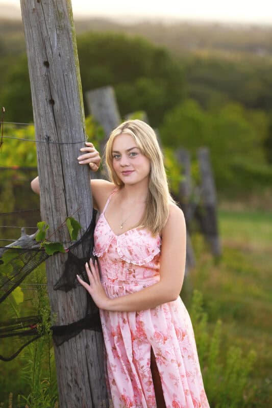 Connecticut senior photographer capturing a high school senior in a pink dress during a vineyard photo session at Gouveia Vineyards.